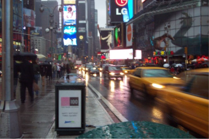 It's tough to take a good picture of Times Square and hold up an umbrella at the same time.